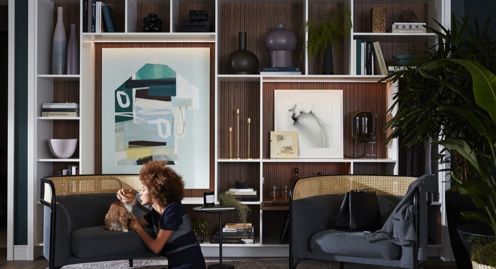 Woman Plays With Cat In Her Neutral Deep Colours Sitting Room