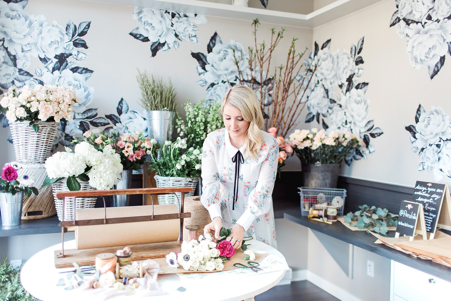 Woman with floral arrangements, UniverCity at Simon Fraser